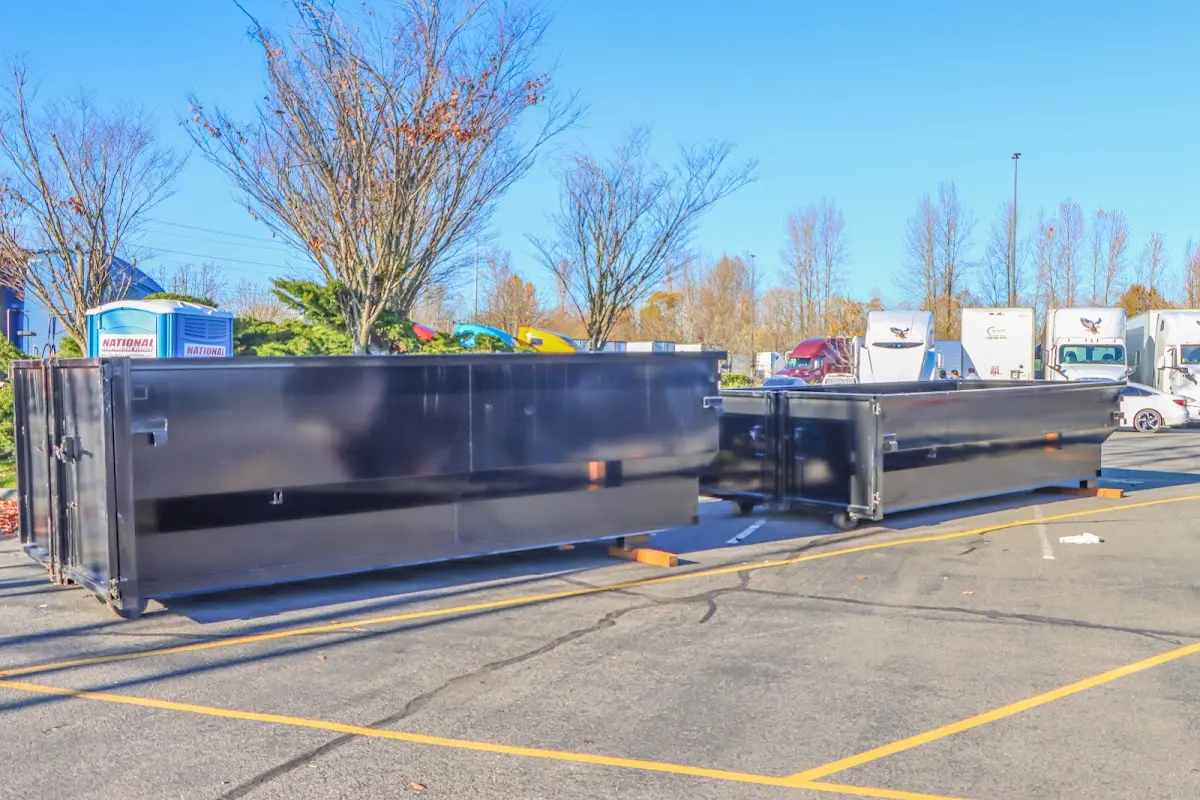 Professional dumpster rental service with roll-off container on residential driveway in Bellview